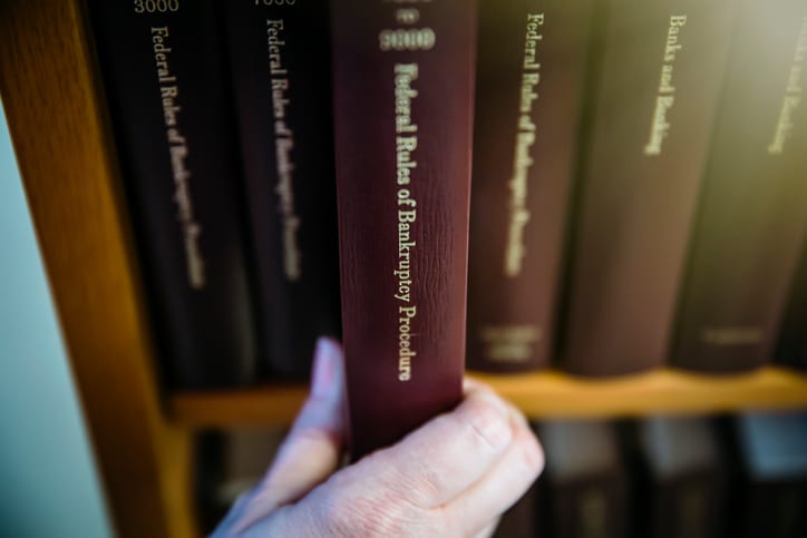 Law Office of Tipton-Downie | Attorney at Law | Vidalia, GA | Caucasian woman selecting reference book from shelf