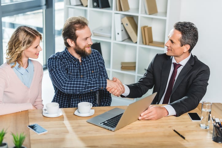 Law Office of Tipton-Downie | Attorney at Law | Vidalia, GA | portrait of smiling lawyer and client shaking hands at meeting in office